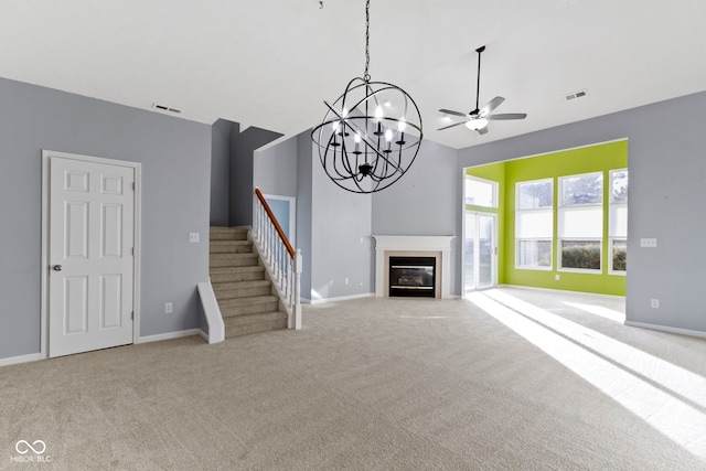 unfurnished living room with ceiling fan with notable chandelier and light carpet