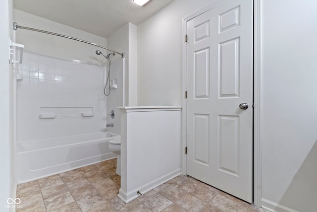 bathroom with tiled shower / bath combo and toilet