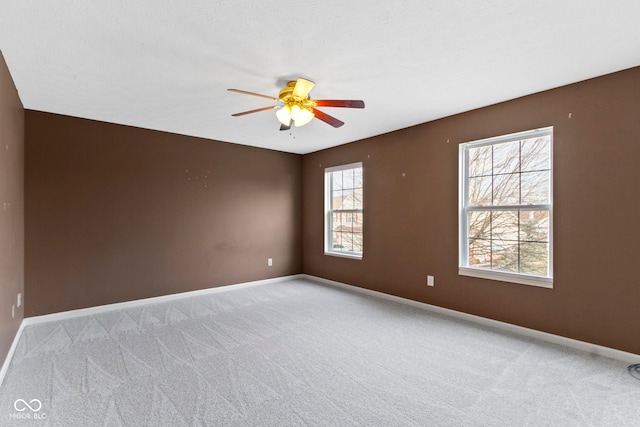 unfurnished room with ceiling fan and light colored carpet