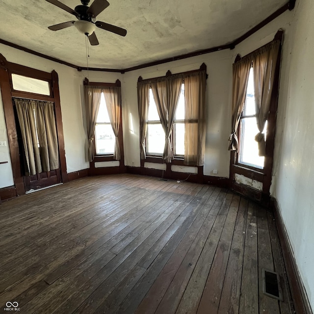 spare room featuring crown molding, dark hardwood / wood-style floors, and ceiling fan