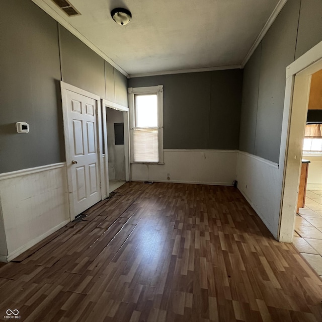 interior space featuring crown molding and dark hardwood / wood-style floors