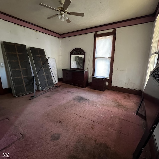 interior space featuring ornamental molding, carpet flooring, and ceiling fan