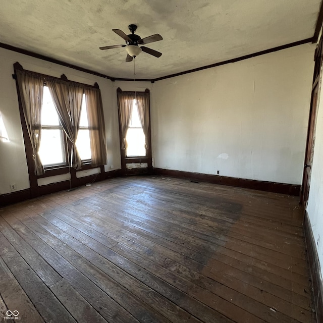 empty room featuring crown molding and dark wood-type flooring