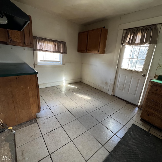 kitchen featuring light tile patterned floors and range hood