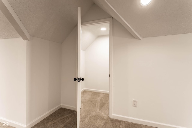 bonus room featuring carpet flooring, vaulted ceiling, and a textured ceiling