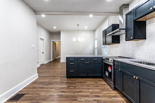 kitchen featuring wall chimney exhaust hood, hanging light fixtures, dark hardwood / wood-style floors, kitchen peninsula, and electric stove