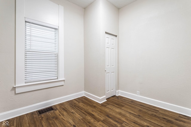 spare room with dark hardwood / wood-style flooring