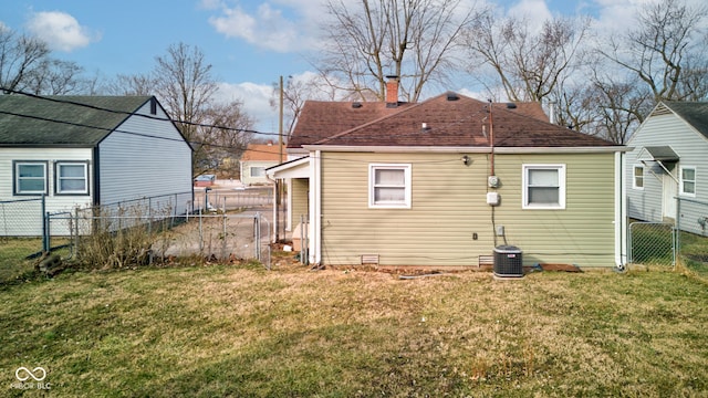 rear view of house featuring a lawn