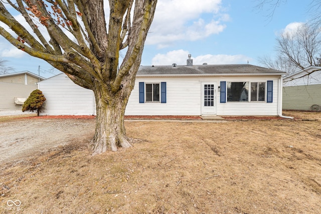 back of house featuring a yard