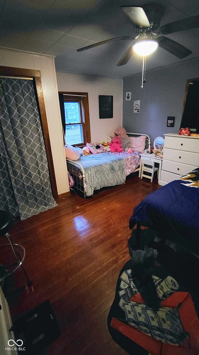 bedroom with ceiling fan and hardwood / wood-style floors