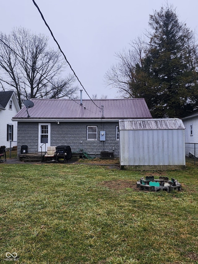 rear view of house with a yard