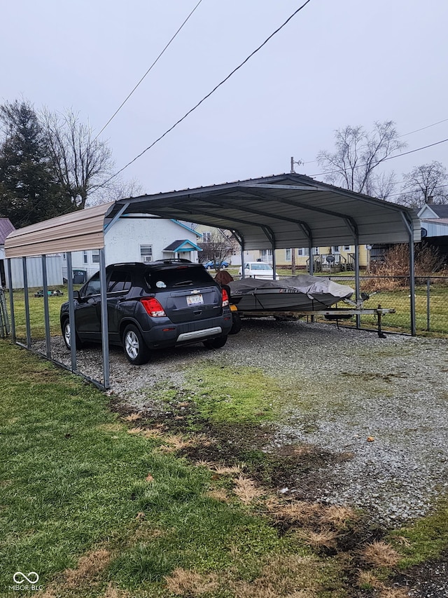 view of vehicle parking with a lawn and a carport