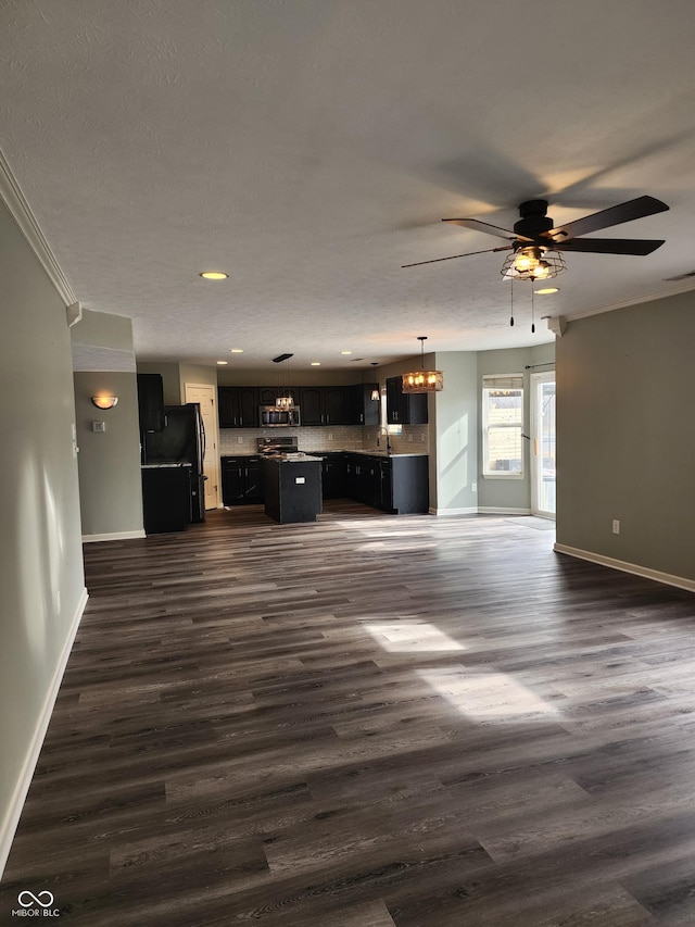 unfurnished living room with dark hardwood / wood-style floors and ceiling fan