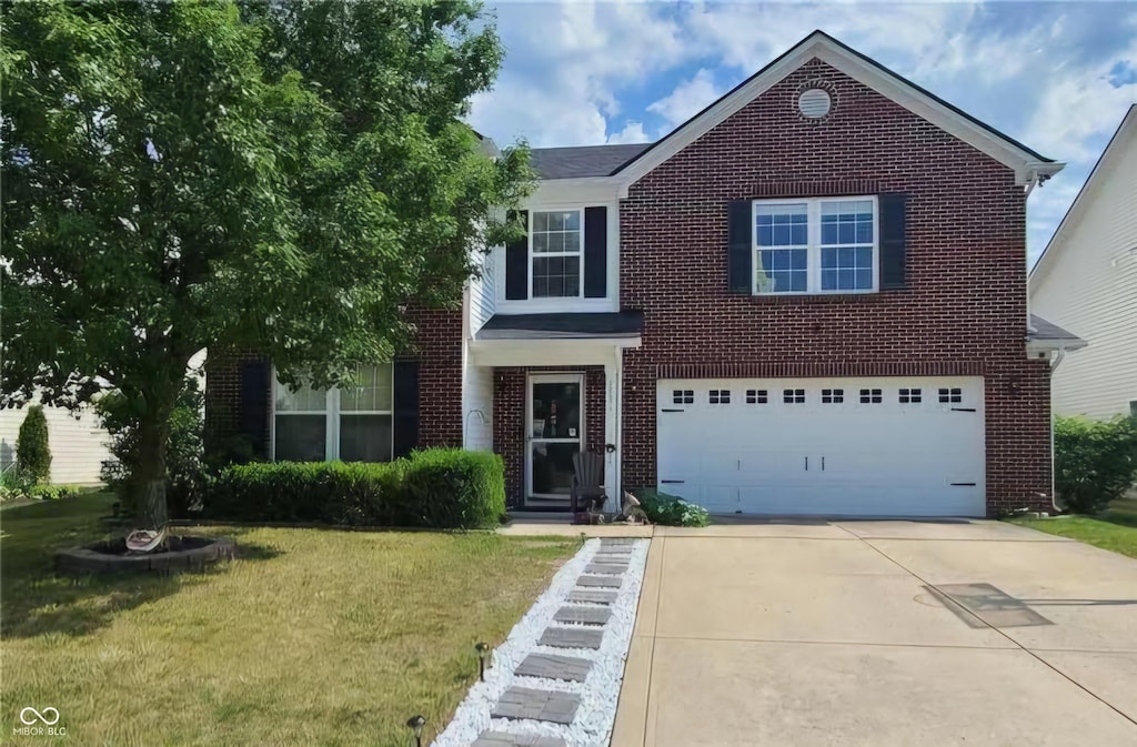 view of front of house with a garage and a front lawn