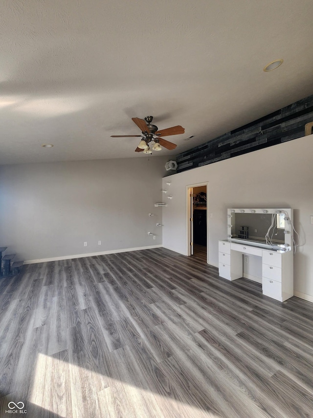 unfurnished living room featuring ceiling fan, a textured ceiling, and light hardwood / wood-style floors