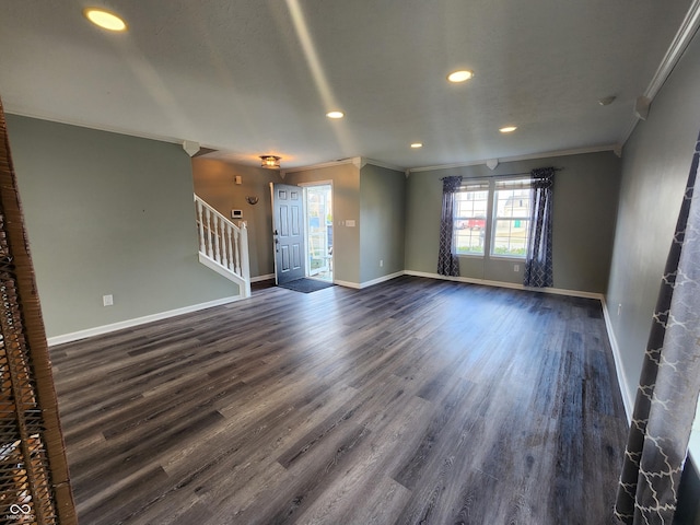 unfurnished living room featuring crown molding and dark wood-type flooring