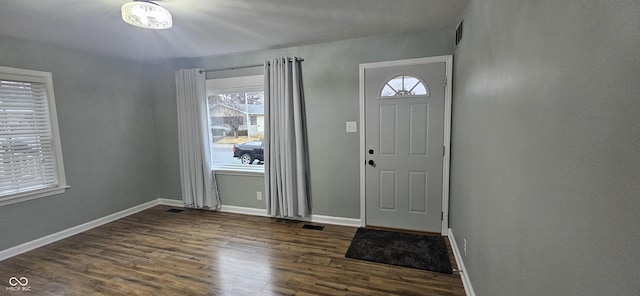 entrance foyer featuring visible vents, baseboards, and dark wood-style flooring