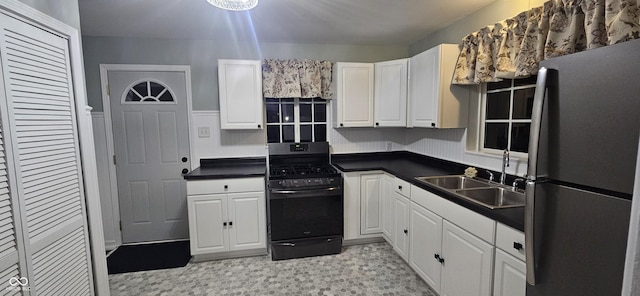 kitchen featuring stainless steel appliances, white cabinetry, and sink