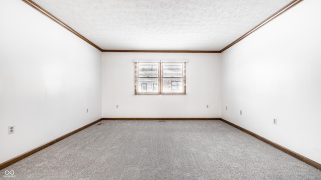 carpeted spare room featuring a textured ceiling, baseboards, and crown molding