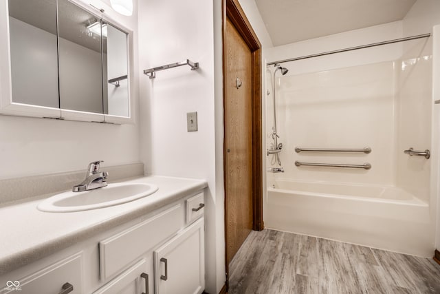 full bath featuring wood finished floors, shower / tub combination, and vanity