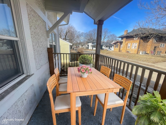 balcony with a residential view and outdoor dining space