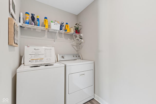 clothes washing area featuring hardwood / wood-style flooring and independent washer and dryer