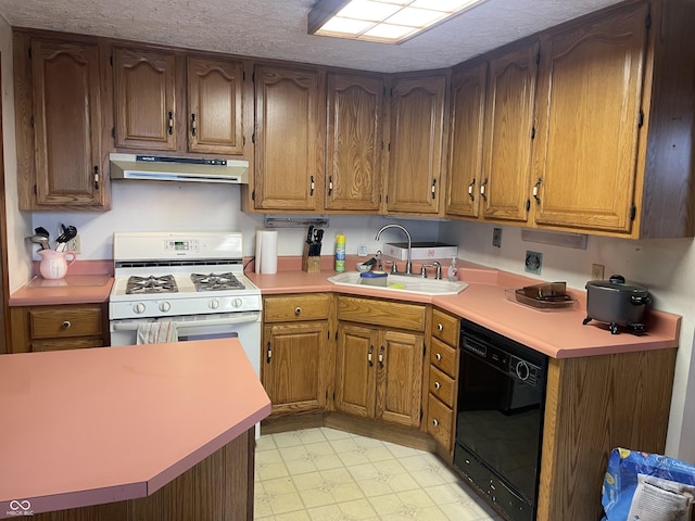 kitchen with black dishwasher, sink, gas range gas stove, and a textured ceiling