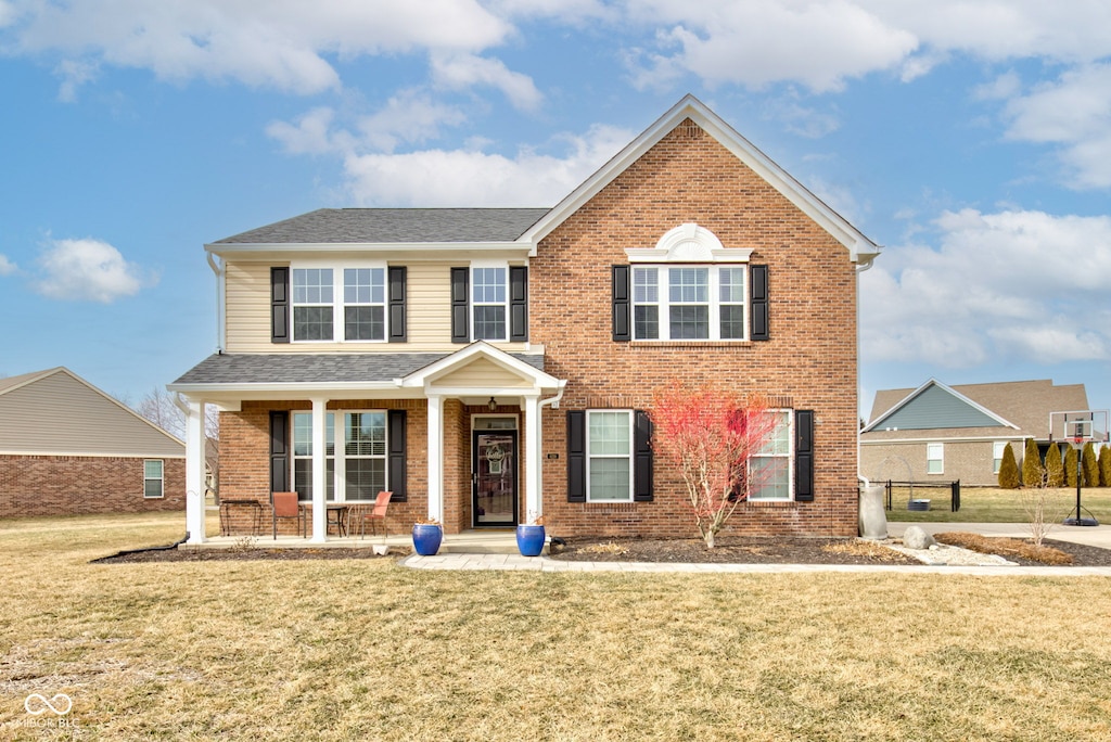 8218 Elsen Rdg, Avon, IN 46123 - traditional-style house with a shingled roof, covered porch, brick siding, and a front lawn