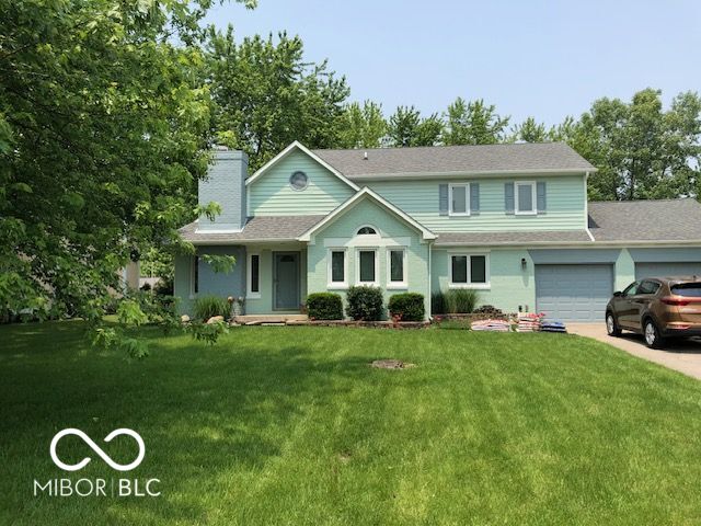 11710 E 75th St, Indianapolis, IN 46236 - view of front facade featuring a garage and a front lawn