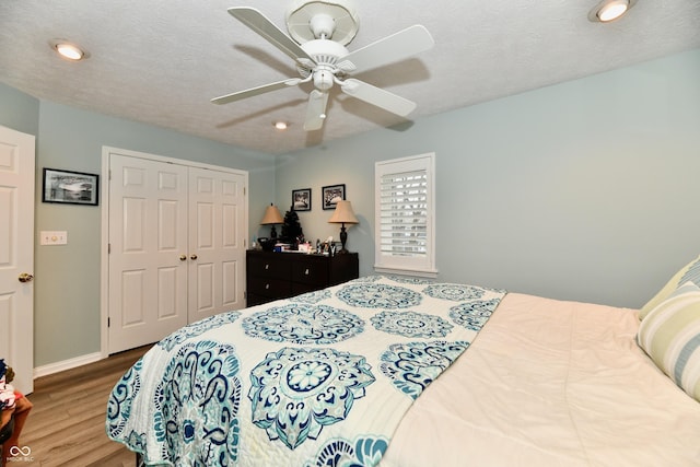 11710 E 75th St, Indianapolis, IN 46236 - bedroom featuring ceiling fan, hardwood / wood-style floors, a textured ceiling, and a closet