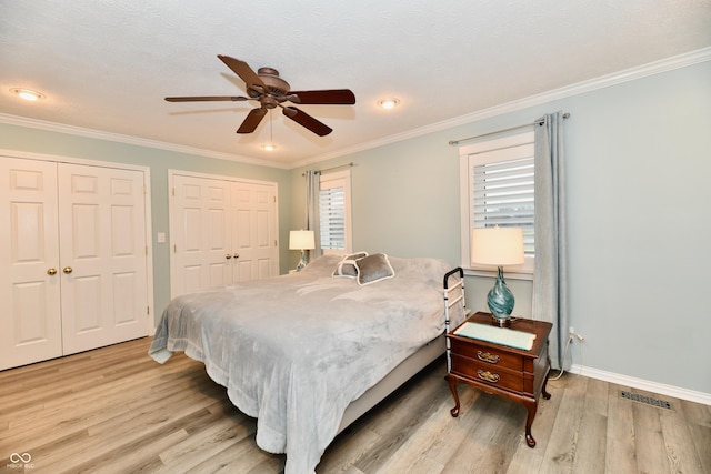 11710 E 75th St, Indianapolis, IN 46236 - bedroom with multiple closets, crown molding, and light wood-type flooring