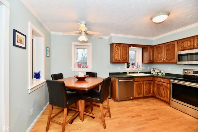 11710 E 75th St, Indianapolis, IN 46236 - kitchen featuring sink, stainless steel appliances, ornamental molding, a textured ceiling, and light wood-type flooring