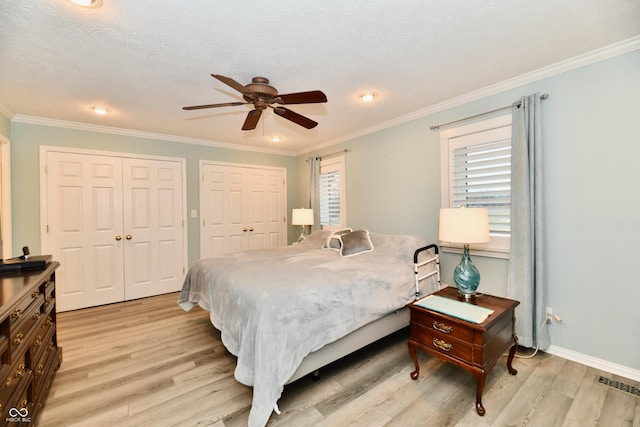 11710 E 75th St, Indianapolis, IN 46236 - bedroom featuring multiple closets, crown molding, and light hardwood / wood-style floors