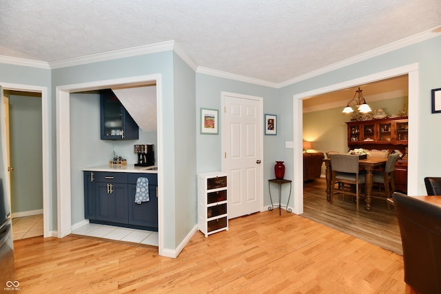 11710 E 75th St, Indianapolis, IN 46236 - interior space with crown molding, pendant lighting, a textured ceiling, and light hardwood / wood-style flooring
