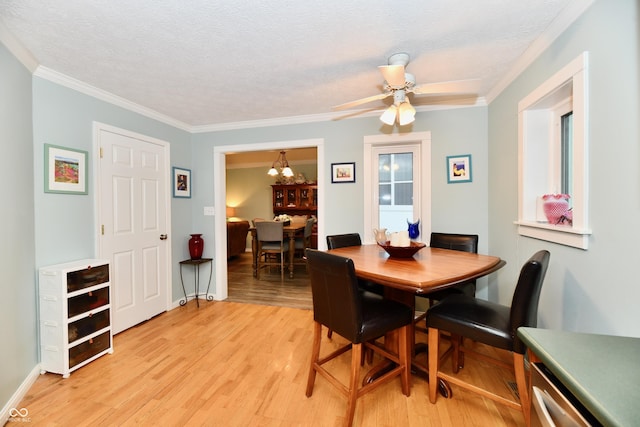 11710 E 75th St, Indianapolis, IN 46236 - dining space with ornamental molding, ceiling fan with notable chandelier, a textured ceiling, and light wood-type flooring