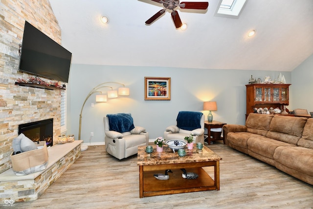 11710 E 75th St, Indianapolis, IN 46236 - living room with lofted ceiling with skylight, ceiling fan, a fireplace, and light hardwood / wood-style flooring