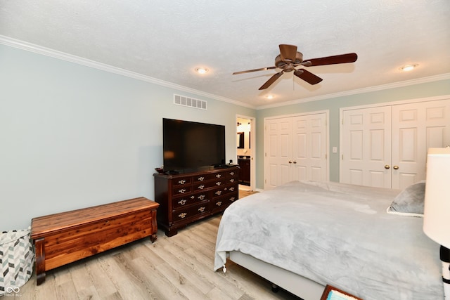 11710 E 75th St, Indianapolis, IN 46236 - bedroom featuring crown molding, two closets, ceiling fan, and light wood-type flooring