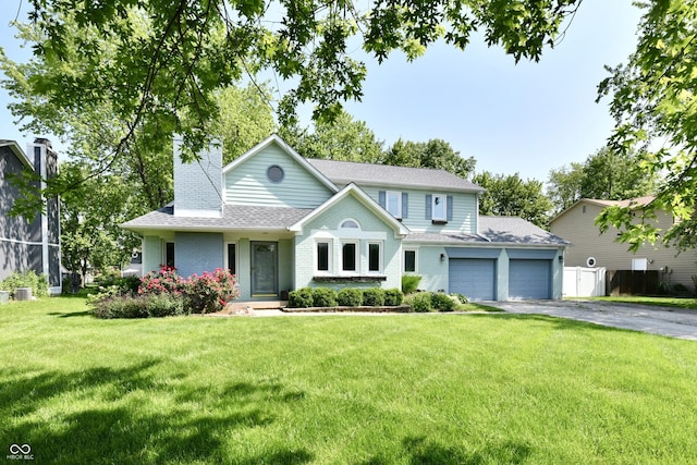 11710 E 75th St, Indianapolis, IN 46236 - view of front of house featuring an attached garage, asphalt driveway, a chimney, a front lawn, and brick siding