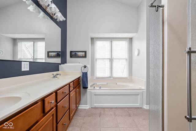 bathroom with a tub to relax in, vanity, and tile patterned flooring