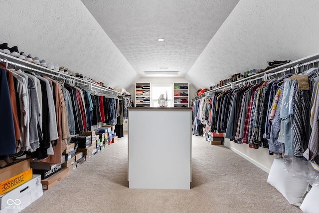 walk in closet featuring vaulted ceiling and carpet floors