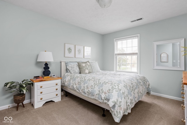 bedroom featuring carpet floors and a textured ceiling