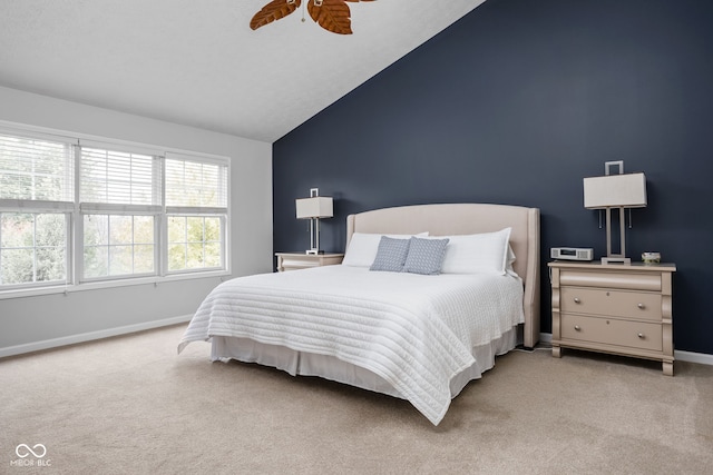 carpeted bedroom featuring vaulted ceiling and ceiling fan