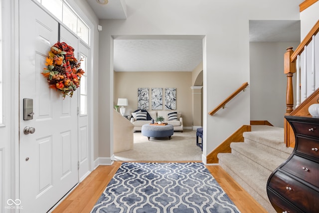 entryway featuring a textured ceiling and light wood-type flooring