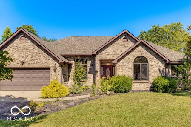 view of front of house with a garage, a shingled roof, brick siding, driveway, and a front lawn