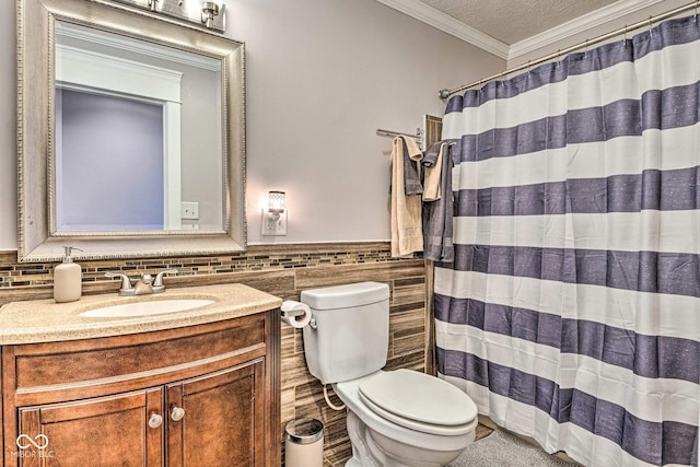 bathroom with toilet, ornamental molding, a textured ceiling, vanity, and tile walls