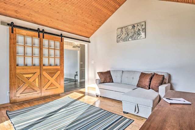 living room featuring wood ceiling, a barn door, high vaulted ceiling, and wood finished floors