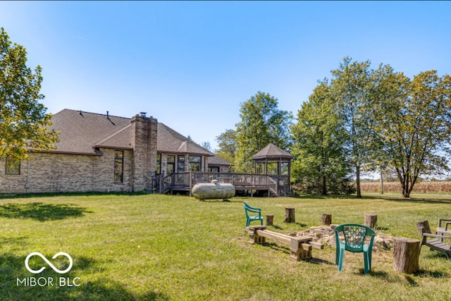 view of yard featuring a deck and a gazebo