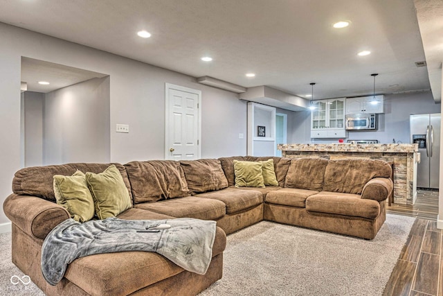 living area featuring dark wood-type flooring and recessed lighting