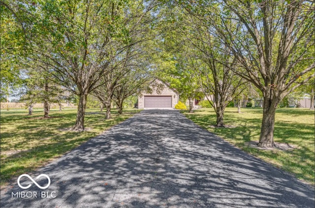 view of front of home with a garage and a front lawn