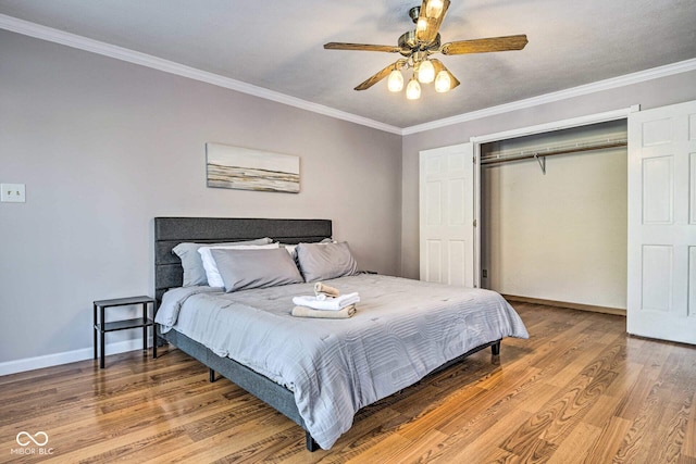 bedroom featuring ornamental molding, a closet, baseboards, and light wood finished floors